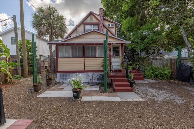 548 3rd St N, Saint Petersburg, FL 33701 - view of front of property with a fenced backyard and a chimney