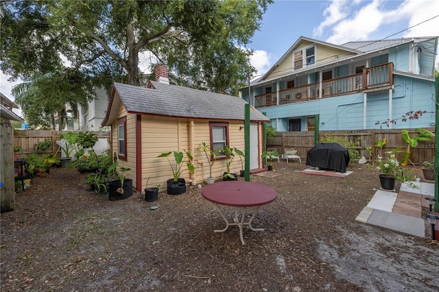 548 3rd St N, Saint Petersburg, FL 33701 - rear view of property featuring an outbuilding, a fenced backyard, and a chimney