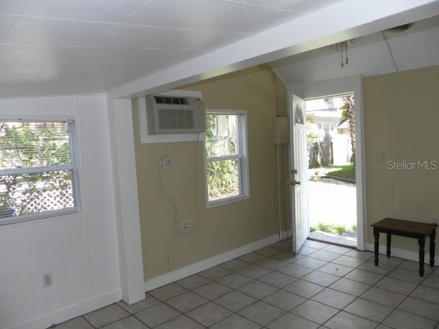 548 3rd St N, Saint Petersburg, FL 33701 - foyer entrance with an AC wall unit, baseboards, and light tile patterned floors