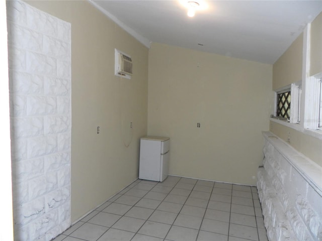 548 3rd St N, Saint Petersburg, FL 33701 - empty room featuring light tile patterned floors and an AC wall unit