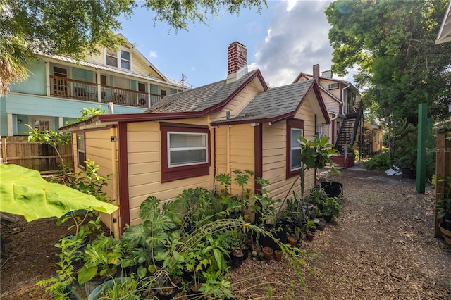 548 3rd St N, Saint Petersburg, FL 33701 - view of side of home with stairs and fence