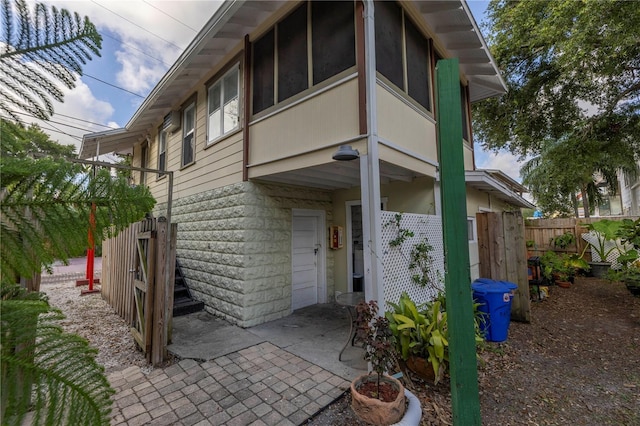 548 3rd St N, Saint Petersburg, FL 33701 - rear view of property with a garage and fence