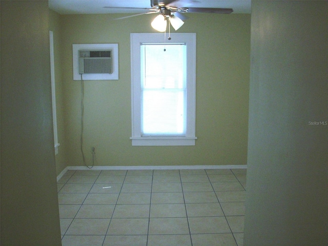 548 3rd St N, Saint Petersburg, FL 33701 - spare room with a wall unit AC, ceiling fan, baseboards, and light tile patterned floors