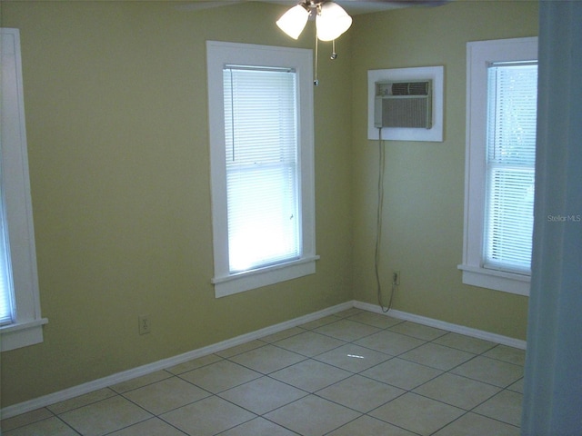 548 3rd St N, Saint Petersburg, FL 33701 - unfurnished room with light tile patterned floors, baseboards, a ceiling fan, and a wall unit AC