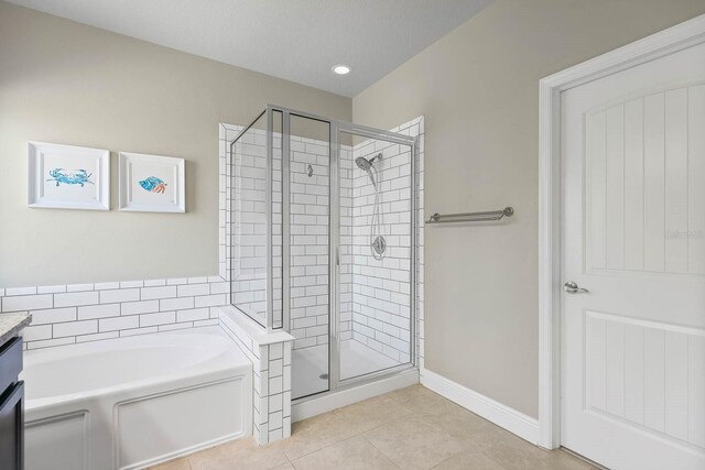 14241 Natures Reserve Dr, Lithia, FL 33547 - bathroom with a shower stall, tile patterned floors, a bath, and vanity