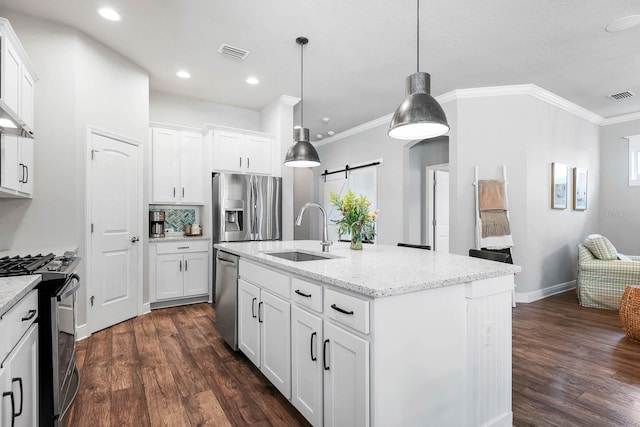 14241 Natures Reserve Dr, Lithia, FL 33547 - kitchen featuring appliances with stainless steel finishes, a sink, a barn door, dark wood-type flooring, and crown molding