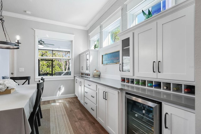 14241 Natures Reserve Dr, Lithia, FL 33547 - kitchen featuring beverage cooler, dark wood finished floors, ornamental molding, white cabinets, and a ceiling fan