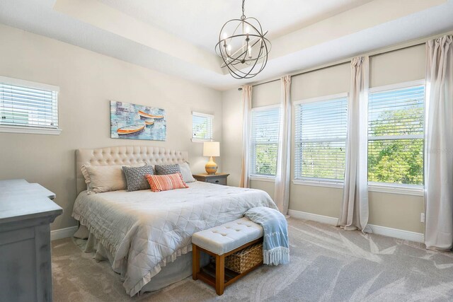 14241 Natures Reserve Dr, Lithia, FL 33547 - bedroom with baseboards, light carpet, and a chandelier