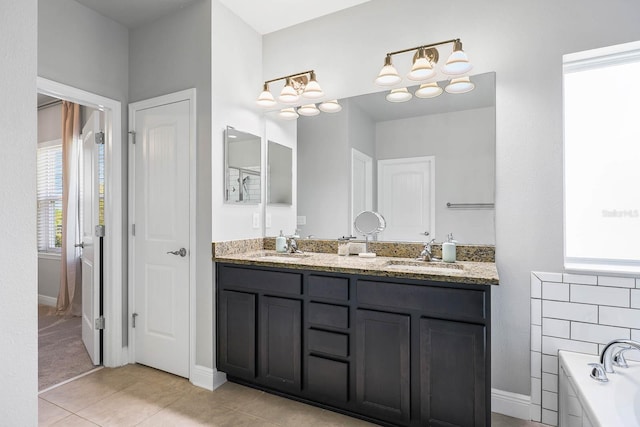 14241 Natures Reserve Dr, Lithia, FL 33547 - full bathroom featuring double vanity, a bath, tile patterned floors, a chandelier, and baseboards