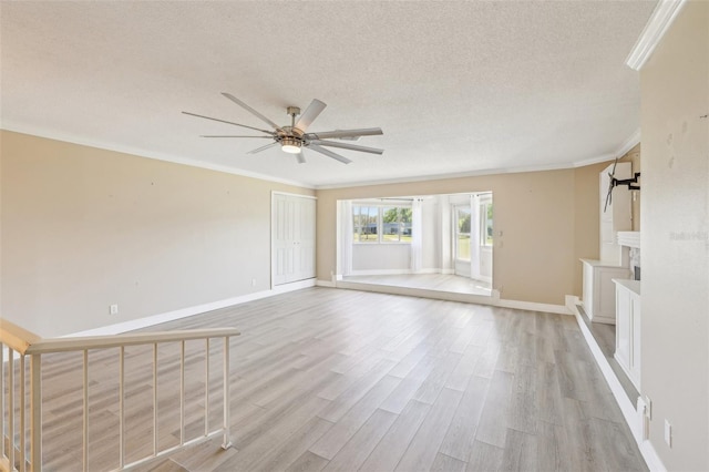 3252 Scorecard Dr, New Port Richey, FL 34655 - unfurnished living room featuring ceiling fan, a textured ceiling, light wood finished floors, and ornamental molding