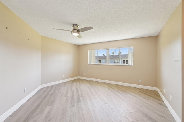3252 Scorecard Dr, New Port Richey, FL 34655 - empty room with light wood-style flooring, a textured ceiling, baseboards, and ceiling fan