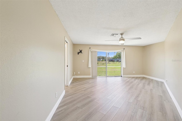 3252 Scorecard Dr, New Port Richey, FL 34655 - spare room with light wood finished floors, baseboards, a textured ceiling, and ceiling fan