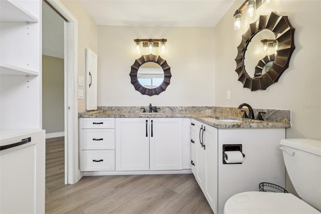 3252 Scorecard Dr, New Port Richey, FL 34655 - bathroom featuring wood finished floors, vanity, and toilet