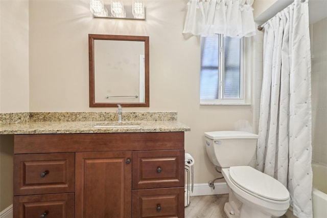 3252 Scorecard Dr, New Port Richey, FL 34655 - full bath with shower / bath combo, toilet, wood finished floors, vanity, and baseboards