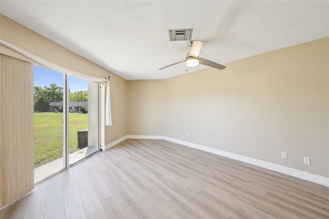 3252 Scorecard Dr, New Port Richey, FL 34655 - empty room featuring visible vents, light wood finished floors, baseboards, and ceiling fan