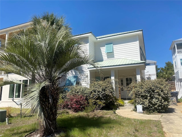 27 Kingfish St, Santa Rosa Beach, FL 32459 - view of front of home featuring metal roof and covered porch