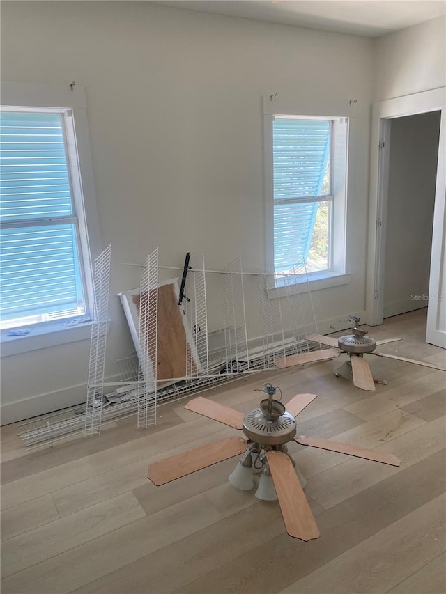 27 Kingfish St, Santa Rosa Beach, FL 32459 - empty room with a ceiling fan, plenty of natural light, baseboards, and wood finished floors
