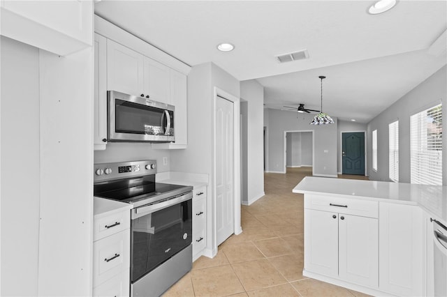 10108 36th Ct E, Parrish, FL 34219 - kitchen featuring stainless steel appliances, ceiling fan, light countertops, light tile patterned flooring, and white cabinets