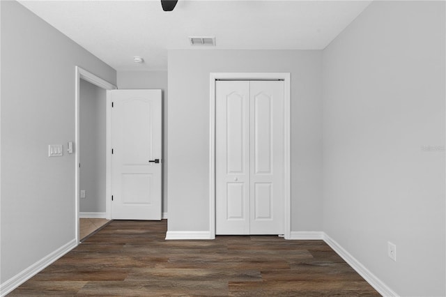 10108 36th Ct E, Parrish, FL 34219 - unfurnished bedroom featuring a closet, dark wood-style flooring, and a ceiling fan