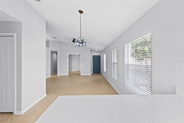 10108 36th Ct E, Parrish, FL 34219 - unfurnished dining area with light tile patterned flooring, vaulted ceiling, and a ceiling fan
