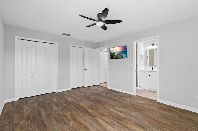 10108 36th Ct E, Parrish, FL 34219 - unfurnished bedroom with two closets, wood finished floors, ensuite bath, and ceiling fan