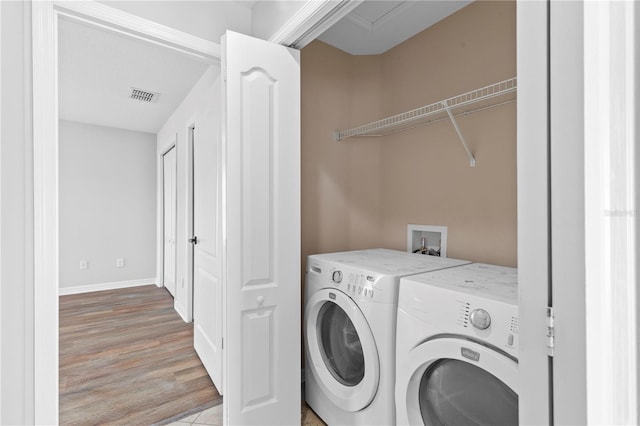 10108 36th Ct E, Parrish, FL 34219 - washroom with washing machine and clothes dryer and wood finished floors