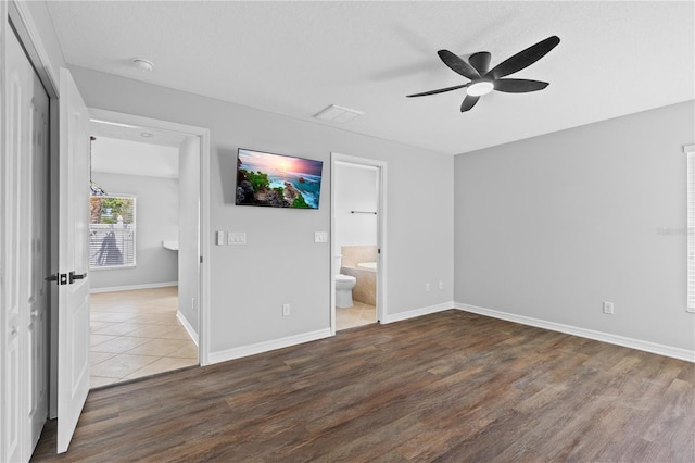 10108 36th Ct E, Parrish, FL 34219 - unfurnished bedroom featuring wood finished floors, ensuite bathroom, and a ceiling fan
