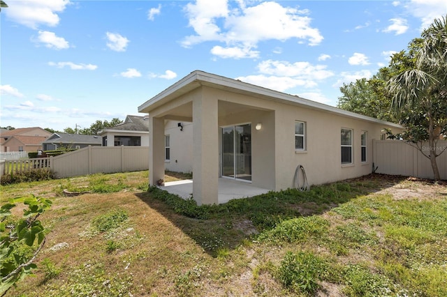 10108 36th Ct E, Parrish, FL 34219 - rear view of property featuring stucco siding and a patio