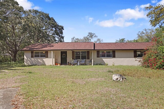 9825 Casey Dr, New Port Richey, FL 34654 - ranch-style home featuring brick siding and a front lawn