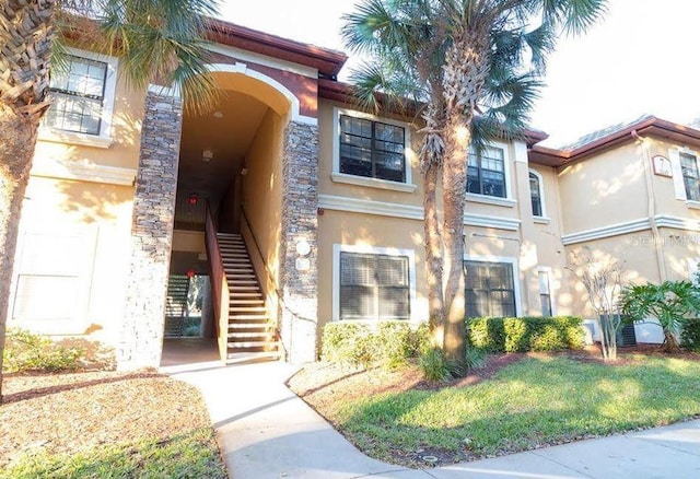 2220 Chianti Pl Unit 8-0817, Palm Harbor, FL 34683 - view of exterior entry featuring stucco siding