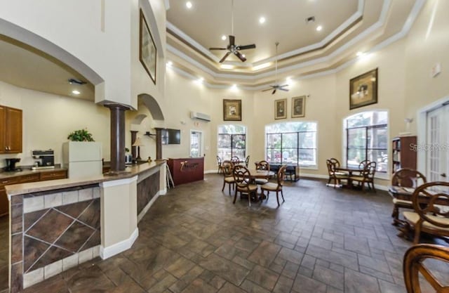 2220 Chianti Pl Unit 8-0817, Palm Harbor, FL 34683 - kitchen with crown molding, a ceiling fan, freestanding refrigerator, a high ceiling, and a tray ceiling