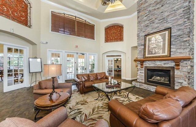 2220 Chianti Pl Unit 8-0817, Palm Harbor, FL 34683 - living area featuring french doors, crown molding, a fireplace, a high ceiling, and baseboards