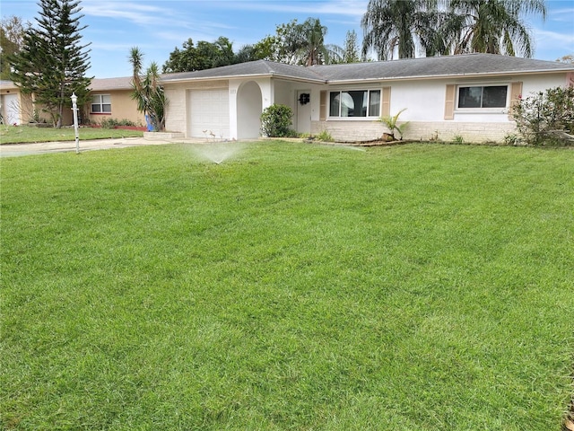 2127 Scotland Dr, Clearwater, FL 33763 - ranch-style house featuring concrete driveway, an attached garage, stucco siding, and a front lawn
