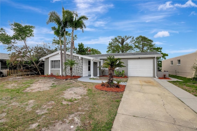 mid-century home with driveway, a garage, fence, and stucco siding