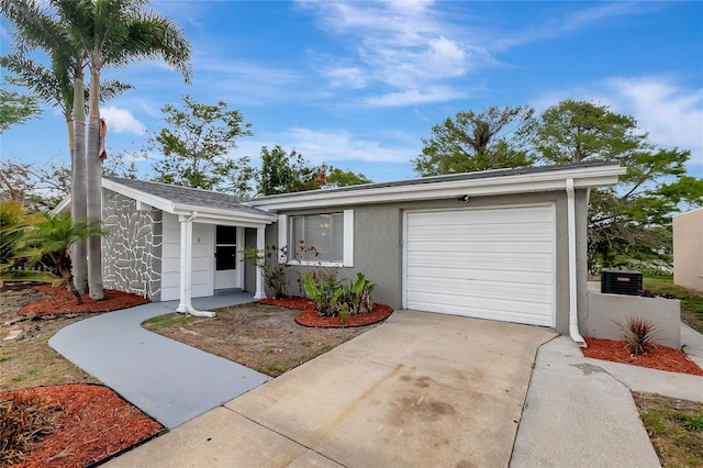 view of front facade featuring driveway, stucco siding, and a garage
