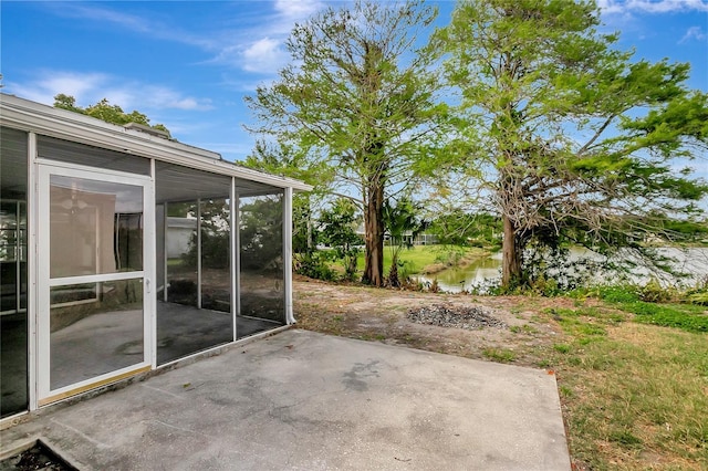 view of patio / terrace featuring a sunroom and a water view