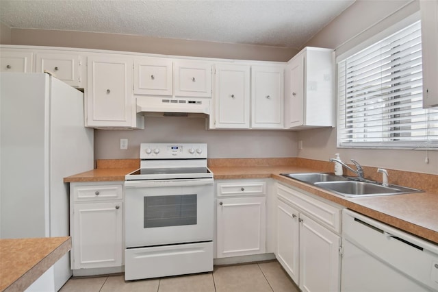 kitchen with white appliances, under cabinet range hood, a sink, and light tile patterned floors