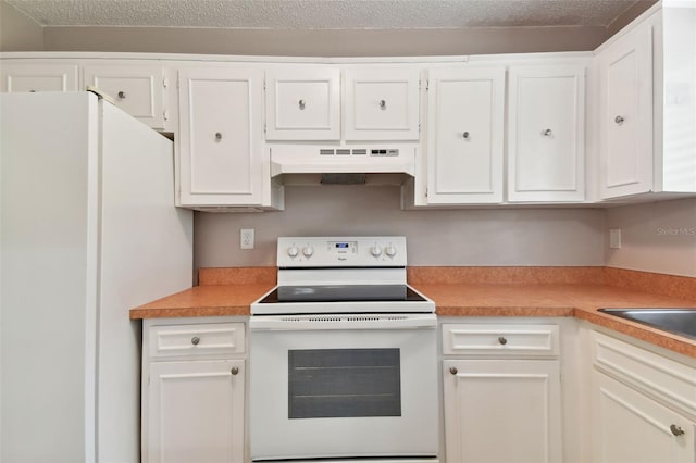 kitchen with white cabinets, light countertops, under cabinet range hood, and white appliances