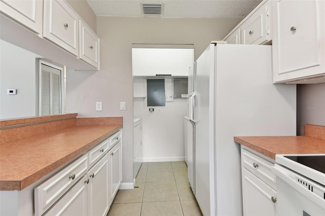 kitchen featuring light tile patterned flooring, visible vents, white cabinetry, and a textured ceiling