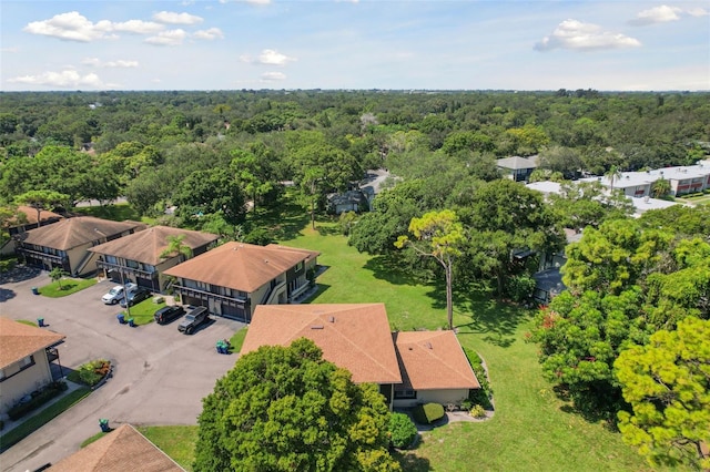 drone / aerial view with a view of trees and a residential view