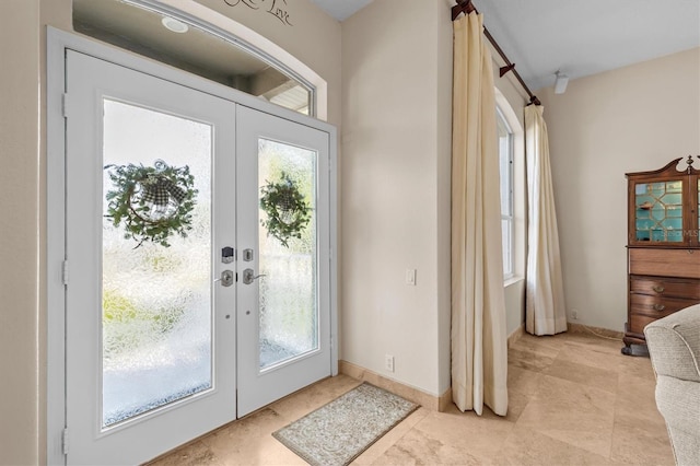 2050 N Pointe Alexis Dr, Tarpon Springs, FL 34689 - doorway featuring french doors, baseboards, and a wealth of natural light