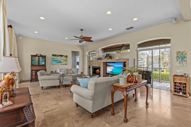2050 N Pointe Alexis Dr, Tarpon Springs, FL 34689 - living room with visible vents, a lit fireplace, ceiling fan, and recessed lighting