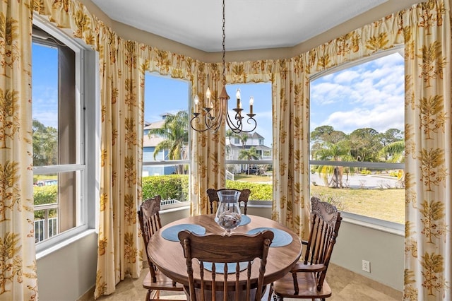 2050 N Pointe Alexis Dr, Tarpon Springs, FL 34689 - dining area with a chandelier and a healthy amount of sunlight