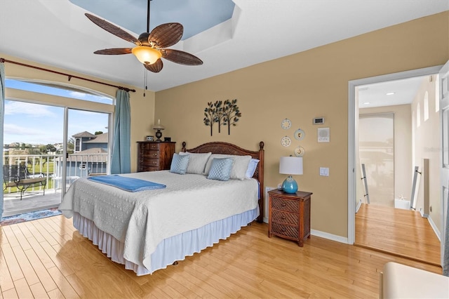2050 N Pointe Alexis Dr, Tarpon Springs, FL 34689 - bedroom with light wood-style floors, baseboards, access to outside, and ceiling fan