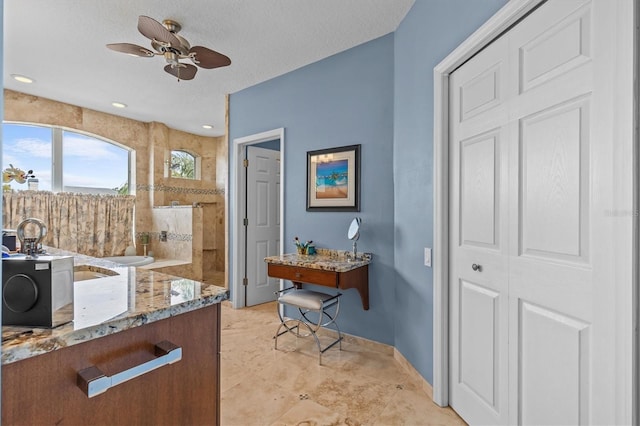 2050 N Pointe Alexis Dr, Tarpon Springs, FL 34689 - full bath featuring vanity, a textured ceiling, walk in shower, baseboards, and ceiling fan