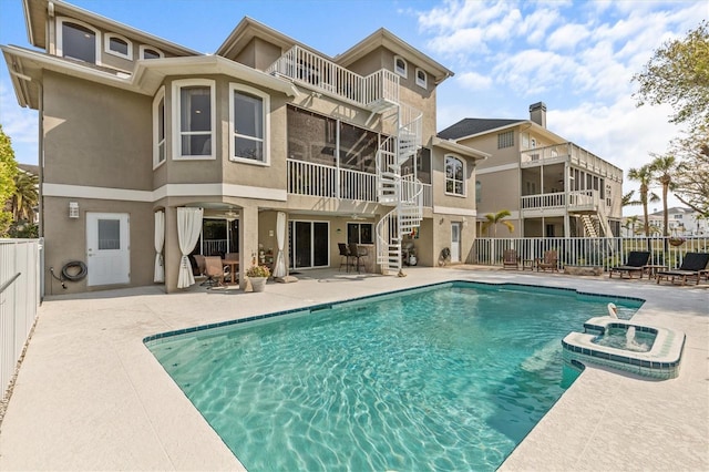 2050 N Pointe Alexis Dr, Tarpon Springs, FL 34689 - view of swimming pool with a pool with connected hot tub, fence, stairs, and a patio