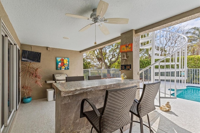 2050 N Pointe Alexis Dr, Tarpon Springs, FL 34689 - view of patio with fence, a fenced in pool, ceiling fan, and outdoor dry bar