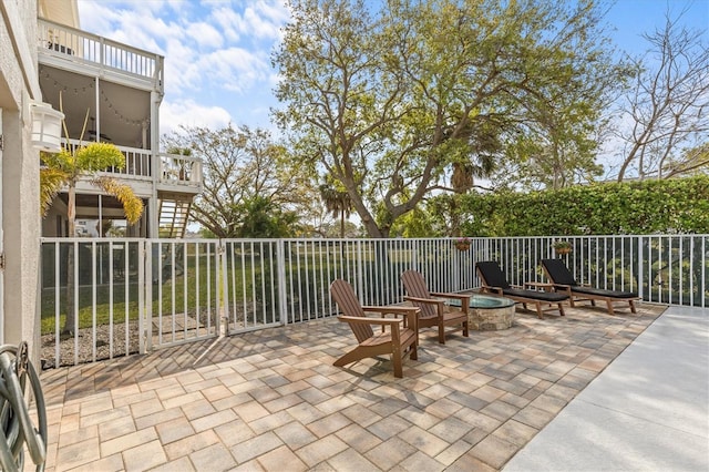 2050 N Pointe Alexis Dr, Tarpon Springs, FL 34689 - view of patio with a balcony, stairs, and a fire pit