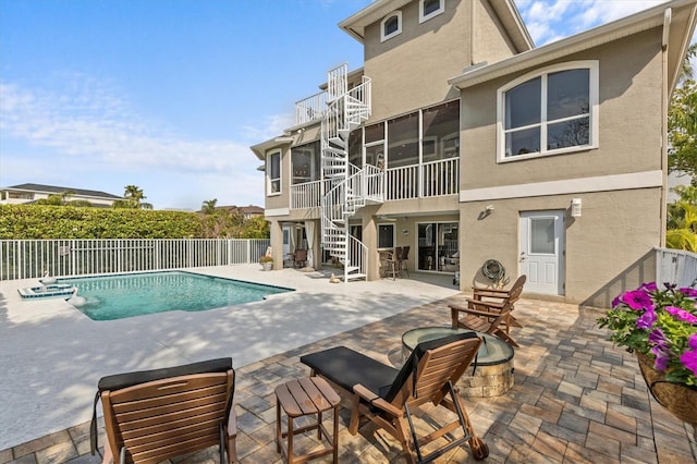 2050 N Pointe Alexis Dr, Tarpon Springs, FL 34689 - view of pool featuring a sunroom, fence, stairway, a fire pit, and a patio area
