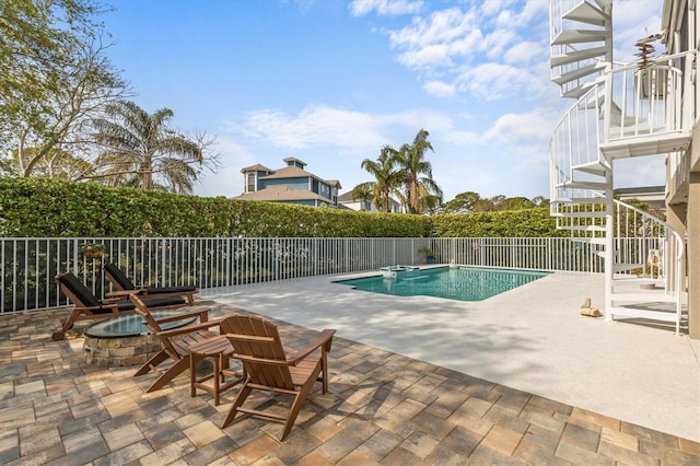 2050 N Pointe Alexis Dr, Tarpon Springs, FL 34689 - view of pool with a fenced in pool, a fire pit, stairway, and a patio area